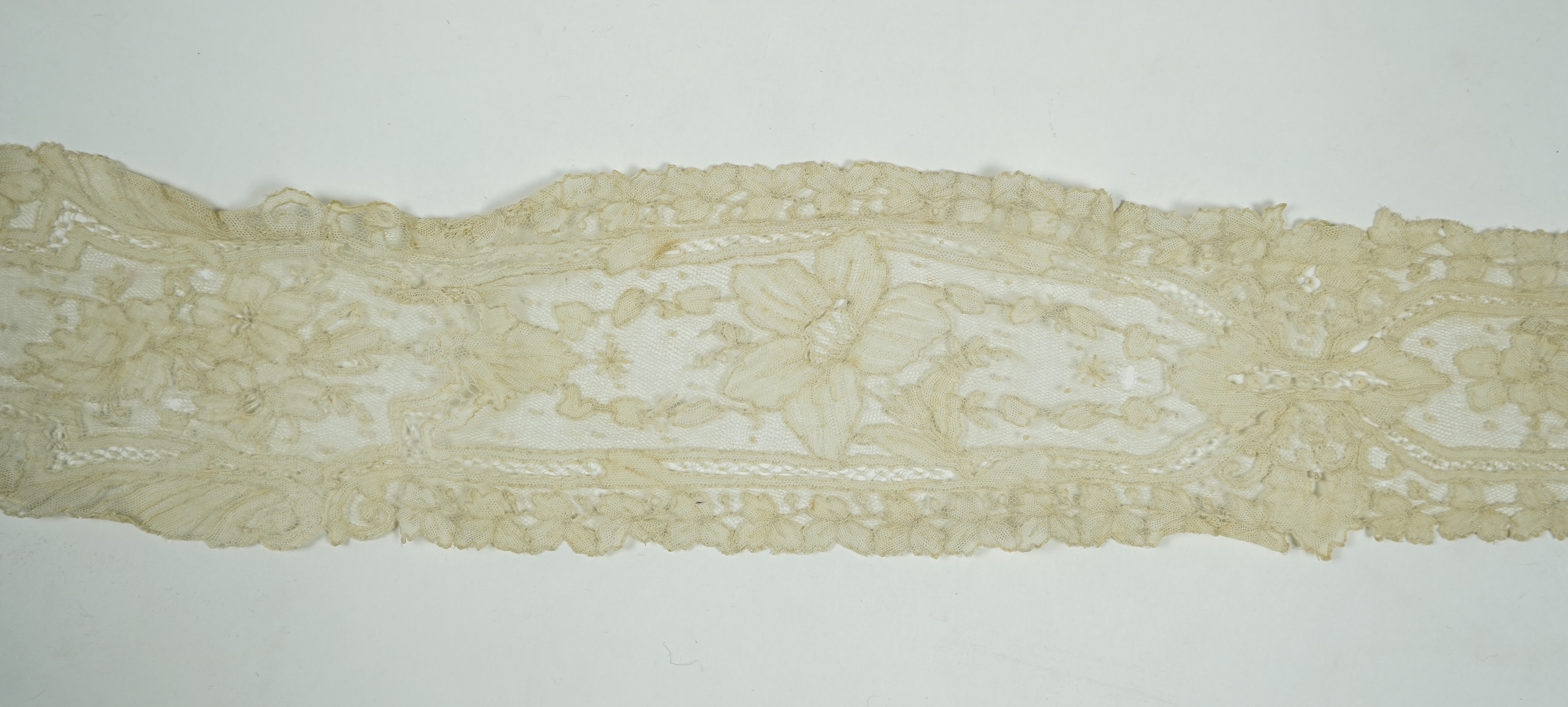 A 19th century Brussels Point de Gaz needle lace collar, lappet and wedding hankie, possibly part of a trousseau. The collar having thirty four needle lace raised flower heads within the design. The collar 100cm long x 1